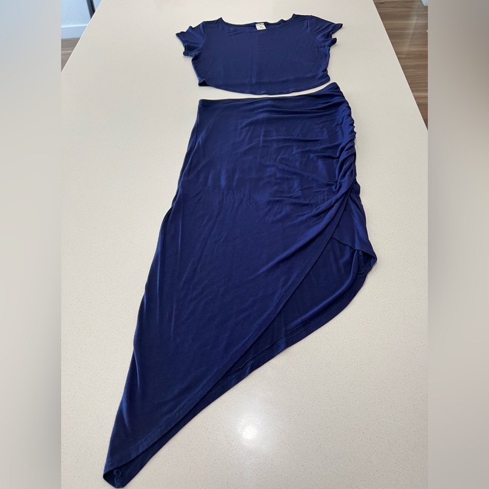 Woman 2 piece skirt and fitted crop top set.